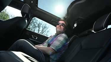 Auto Express web producer Pete Baiden sitting in the Honda e:Ny1's back seat